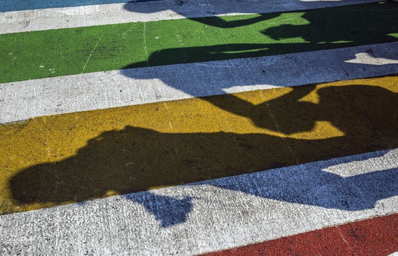 FILE — Shadows of pedestrians overlay the colorful stripes of a rainbow crosswalk near the historic Stonewall Inn in New York, June 28, 2019. Some cities have gotten letters from the Federal Highway Administration requesting that colorful crosswalk designs be removed for safety reasons, but some urban planners and advocates say the government’s claims of safety concerns are not rooted in evidence. (Brittainy Newman/The New York Times) XNYT80 XNYT80 (BRITTAINY NEWMAN / NYT)