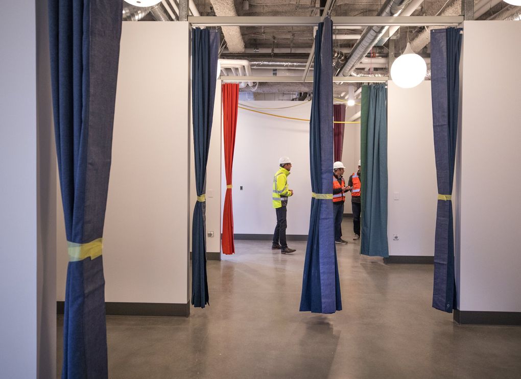 Flexible sleeping spaces on one floor of the new Mary’s Place shelter at Amazon can be closed off with curtains. This area is designed for families in a diversion program meant to quickly help them back into stable housing. (Steve Ringman / The Seattle Times)