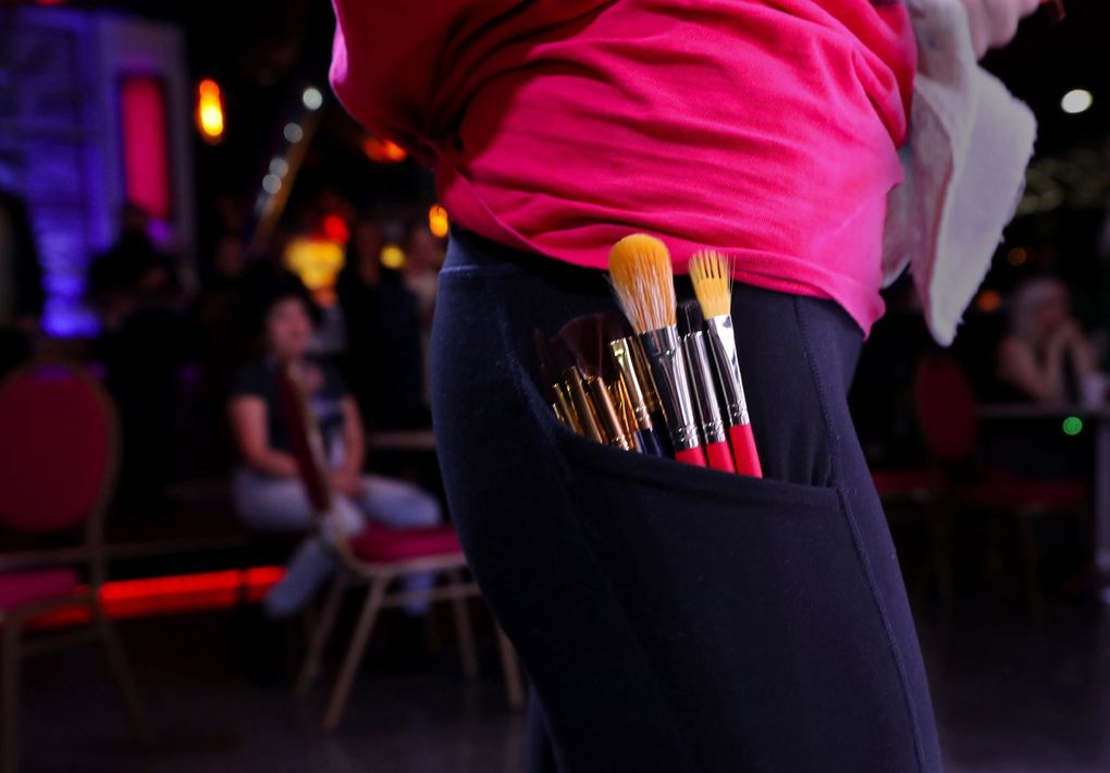 Ciera Christensen keeps her brushes at the ready at last month’s Art Battle Seattle. (Alan Berner / Seattle Times)
