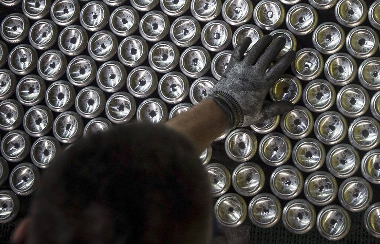 An employee inspects aluminum beverage cans as they pass along the production line at the Ball Packaging Europe Ltd. plant, in Belgrade, Serbia, on Wednesday, March 14, 2018. The U.K. will rely on the European Union to make the case for an exemption from U.S. President Donald Trump’s steel and aluminium tariffs, even though the country is due to leave the bloc in a year’s time. Photographer: Oliver Bunic/Bloomberg 775141700
