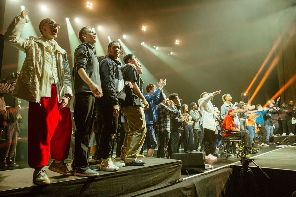 The Residency youth celebrate on stage during a fundraising concert at the Paramount Theatre. (Haley Blavka)