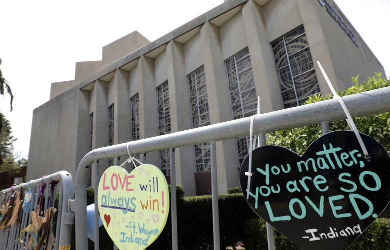 FILE – This file photo from Sept. 17, 2019 shows signs hanging on a fence surrounding the Tree of Life synagogue in Pittsburgh.  Leaders of the Pittsburgh synagogue where worshippers were fatally shot last year want to rebuild and renovate the building, turning it into what they hope will be a â€œcenter for Jewish life in the United Statesâ€ and a symbol against hatred. On Friday, Oct. 18, 2019 they outlined their vision for the Tree of Life building, where three congregations _ Tree of Life, Dor Hadash and New Light _ had gathered on Oct. 27, 2018. A gunman opened fire, killing 11 people and wounding seven.   (AP Photo/Gene J. Puskar, File) PAKS302 PAKS302