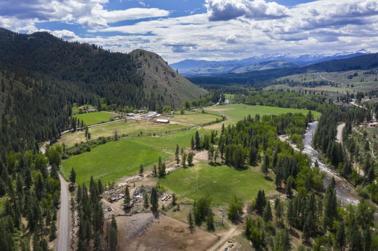Don Lundgren’s family ranch sits next to the Chewuch River. Lundgren hoped to sell water rights to Crown Columbia for potential use beyond the Methow Valley, in the distance. (Steve Ringman / The Seattle Times)