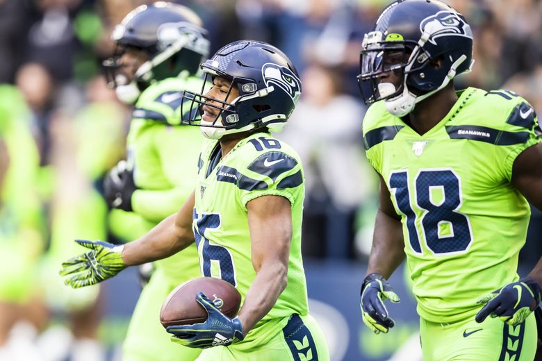 Wide receiver Tyler Lockett of the Seattle Seahawks smiles between