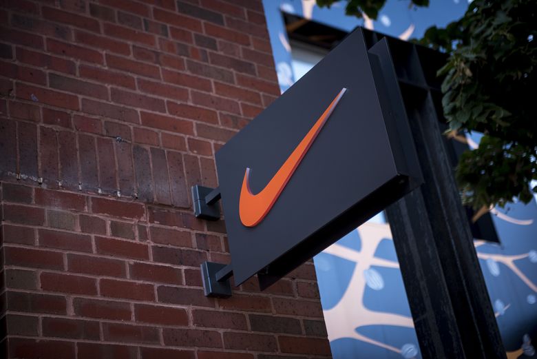 A logo hangs on display outside a Nike Inc. store in Chicago, Illinois, U.S., on Sunday, Sept. 24, 2017. (Bloomberg)