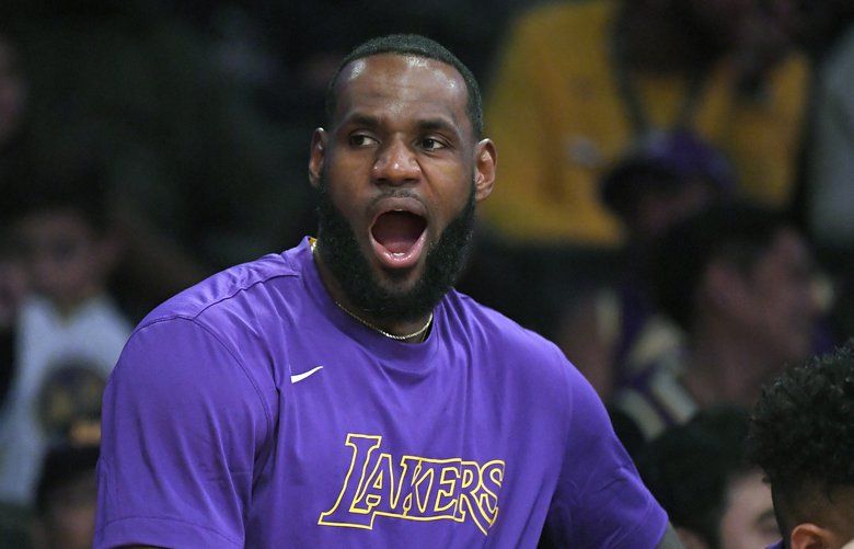 Los Angeles Lakers forward LeBron James yawns as he sits on the bench during the second half of a preseason NBA basketball game against the Golden State Warriors, Monday, Oct. 14, 2019, in Los Angeles. The Lakers won 104-98. (AP Photo/Mark J. Terrill) LAS111 LAS111