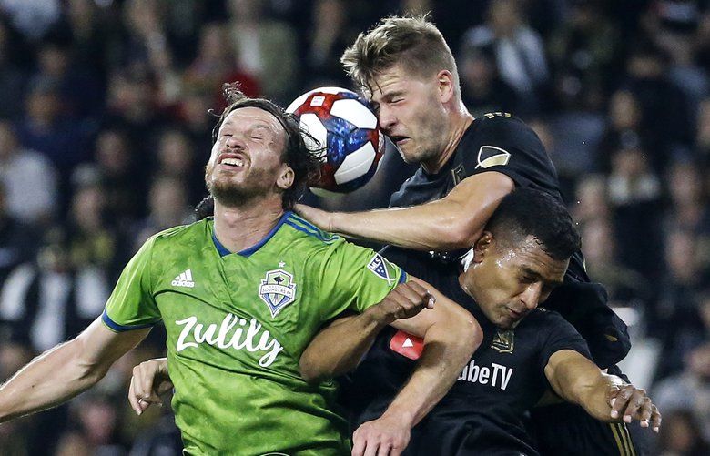 Seattle Sounders midfielder Gustav Svensson, left, vies for a head ball against Los Angeles FC defenders Walker Zimmerman, center, and Eddie Segura during the first half of the MLS soccer Western Conference final Tuesday, Oct. 29, 2019, in Los Angeles. (AP Photo/Ringo H.W. Chiu) CARC108 CARC108