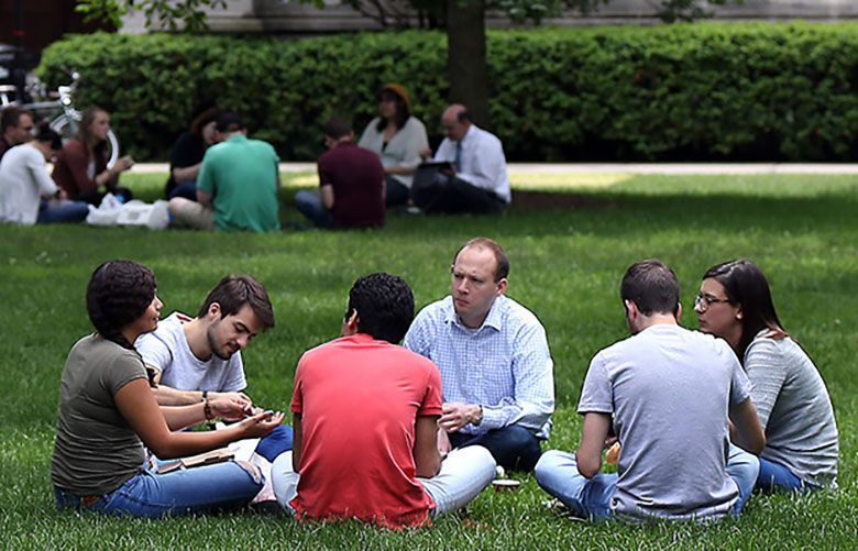 People sit on the main quadrangle of the University of Chicago campus. (Chicago Tribune file photo via TNS)