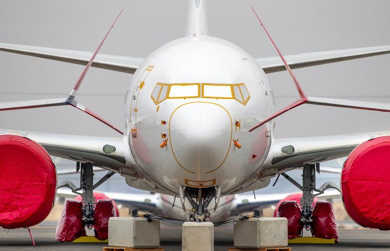 The nose section of a 737 MAX, framed by the wingtips of neighboring 737s, have their engines, landing gear, and front nose sensors protected from the weather at the Grant County International Airport in Moses Lake Washington. Nearly 200 completed Boeing 737 MAX airplanes, built for airlines worldwide, are currently parked at his Eastern Washington airport.
 In March 2019, aviation authorities around the world grounded the passenger airliner after two separate crashes.

Photographed on November 13, 2019. 212113 212113