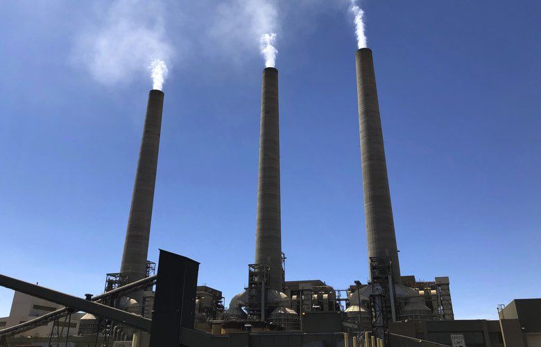 This Aug. 20, 2019, image shows a trio of concrete stacks at the Navajo Generating Station near Page, Ariz. The power plant will close before the year ends, upending the lives of hundreds of mostly Native American workers who mined coal, loaded it and played a part in producing electricity that powered the American Southwest. (AP Photo/Susan Montoya Bryan) RPSB101