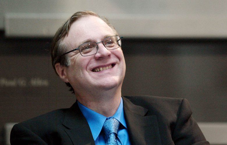 Paul Allen, Microsoft co-founder, smiles as he listens to other speakers during the dedication of the Paul G. Allen Center for Computer Science & Engineering at the University of Washington in Seattle on Thursday, Oct. 9, 2003. Allen contributed $14 million to the $72 million project. (AP Photo/John Froschauer)