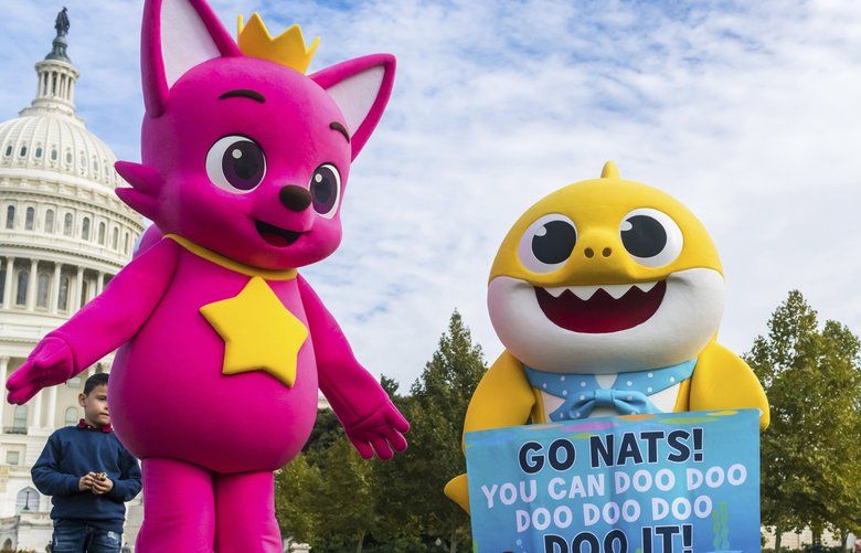 In this Friday, Oct. 25, 2019, Pinkfong and Baby Shark cheer on the Washington Nationals with fans of all ages ahead of Game 3 of the World Series, while gifting WowWee’s official Baby Shark toys at various landmarks in Washington. The â€œBaby Sharkâ€ tour is launching a new set of concert dates after recently wrapping up dozens of performances in its first run in North America. The second leg of the tour kicks off in Independence, Missouri on March 1, 2020.  (Rodney Choice/AP Images for Pinkfong Baby Shark & WowWee) NYCD302 NYCD302