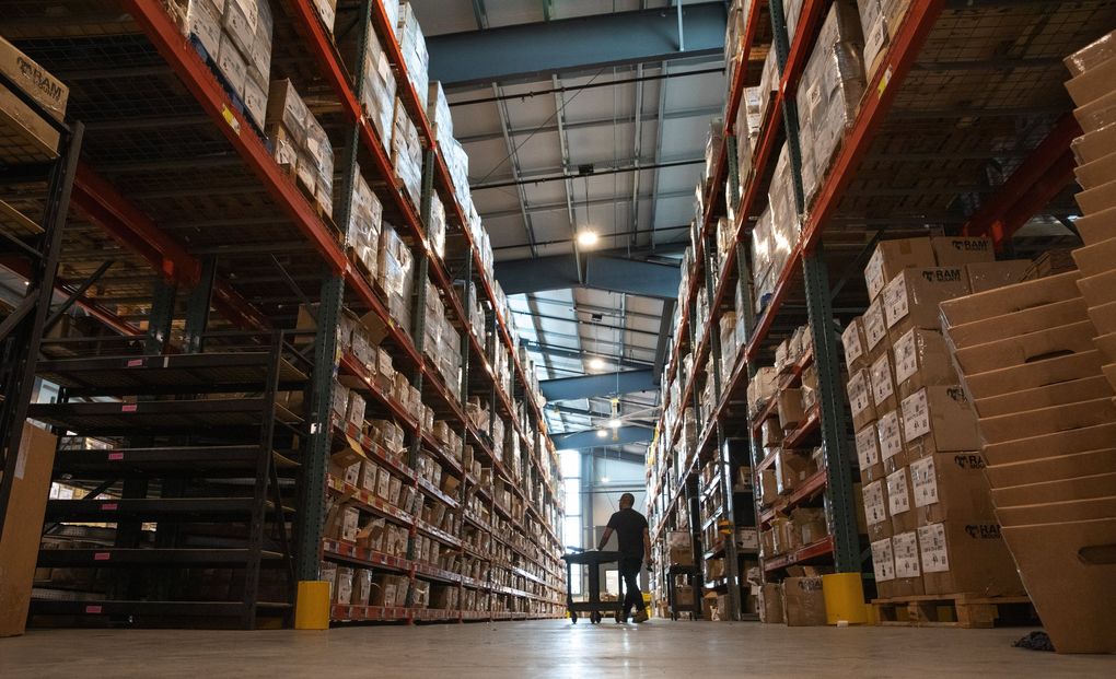 Employees at RAM Mounts work in a storage building at the company’s Seattle location. The South Park company began with Jeff Carnevali’s design for a ball-and-socket mount, which was first produced in his own basement, along the Duwamish River. (Ellen M. Banner / The Seattle Times)
