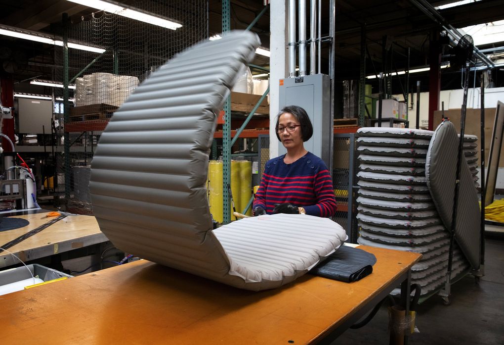 Rosela Martin, a production specialist at Cascade Designs in South Seattle, inflates a Therm-a-Rest sleeping pad. All pads are left inflated for at least two days to be sure they don’t leak air. Therm-a-Rest mattresses were invented by three Seattle engineers. (Ellen M. Banner / The Seattle Times)
