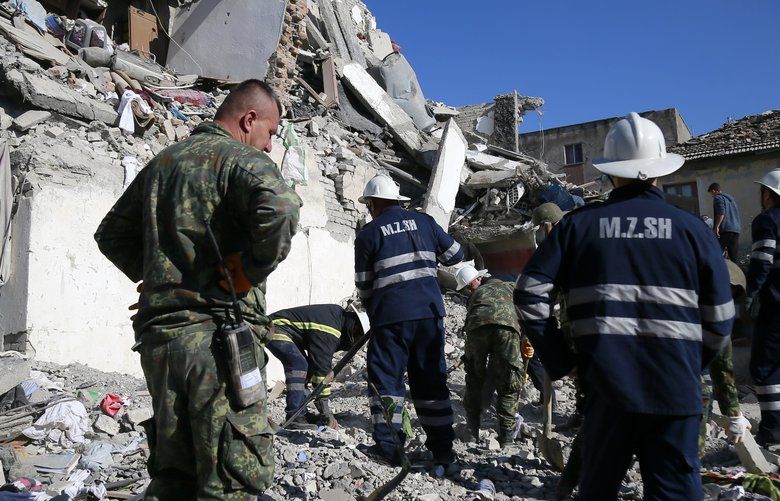 Rescuers search at a damaged building after a magnitude 6.4 earthquake in Thumane, western Albania, Tuesday, Nov. 26, 2019. Rescue crews used excavators to search for survivors trapped in toppled apartment buildings after a powerful pre-dawn earthquake in Albania killed at least six people and injured more than 300. (AP Photo/Visar Kryeziu) XTS126 XTS126