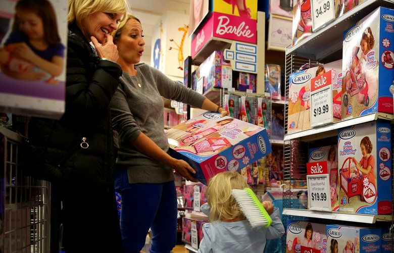 Happy to find items the girls liked, (From left) Joanne Wright, of Michigan, and her daughter-in-law Alison Wright, of West Hollywood, navigate the sale aisles  at Toys R Us on La Cienega Blvd. with Alison’s twin daughters, both 23 months-old, in tow. They braved the Black Friday shopping scene at Toys R Us on La Cienega Blvd.  in order to see what kinds of toys the girls showed interest in and to get some early Christmas shopping done before Joanne had to get back on a plane to Michigan tomorrow. ( Liz O. Baylen  / Los Angeles Times /TNS) 1501380 1501380
