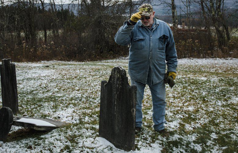 Frank Hull visits the family plot on his family farm in Durham, N.Y. on Nov. 14, 2019, where many of the tombstones date back as far as the Revolutionary War. The Hulls can no longer handle the strenuous physical work needed to earn enough to keep up with the taxes, insurance, mortgages, barn maintenance and other rising costs, so they are putting the farm on the market. (Sara Naomi Lewkowicz/The New York Times) XNYT118