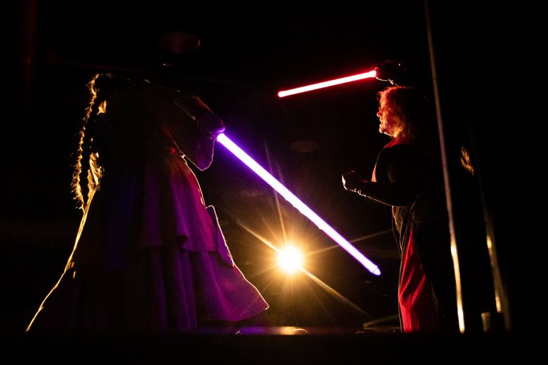 Kamino Temple performer Caitlin Jacques, left, crosses lightsaber blades with her sister and fellow performer Shawna Jacques during a performance at GeekGirlCon last month in Seattle. (Andy Bao / The Seattle Times)