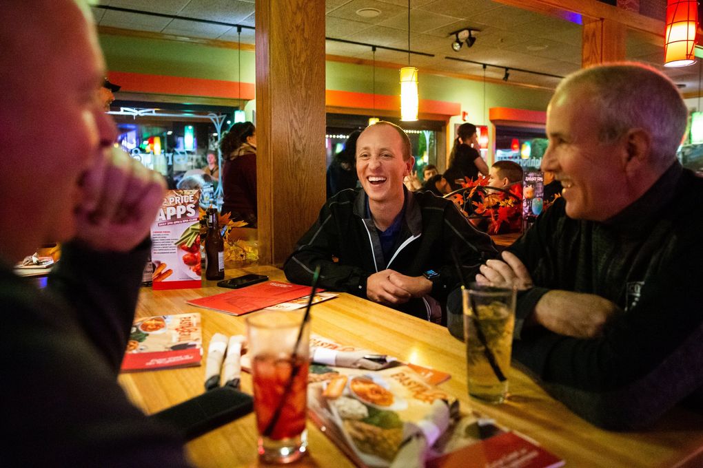 Referee Tyler Trimble, center, grabs drinks at Applebee’s with fellow referees after a Friday night football game between Adna High School and Onalaska High School in Adna on Oct. 25. “We’re real people. We enjoy the sport and love what we do” Trimble said.
(Andy Bao / The Seattle Times)