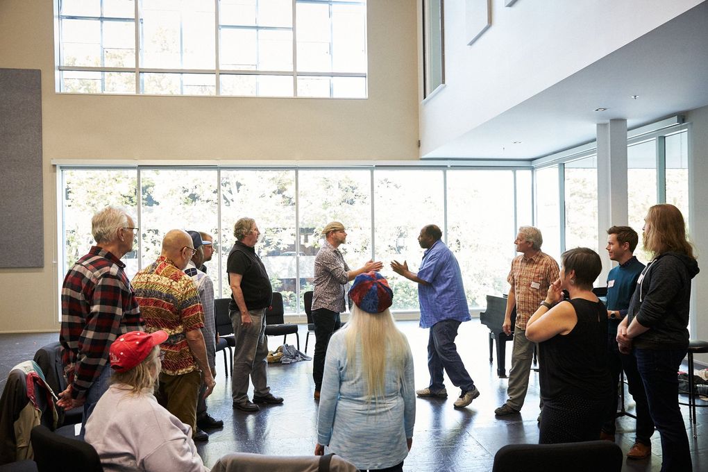 Veterans from the nonprofit Path with Art rehearse at the Opera Center in preparation for “The Falling and the Rising.” Seattle Opera’s production of the chamber opera features a chorus made up of local veterans. (Philip Newton)