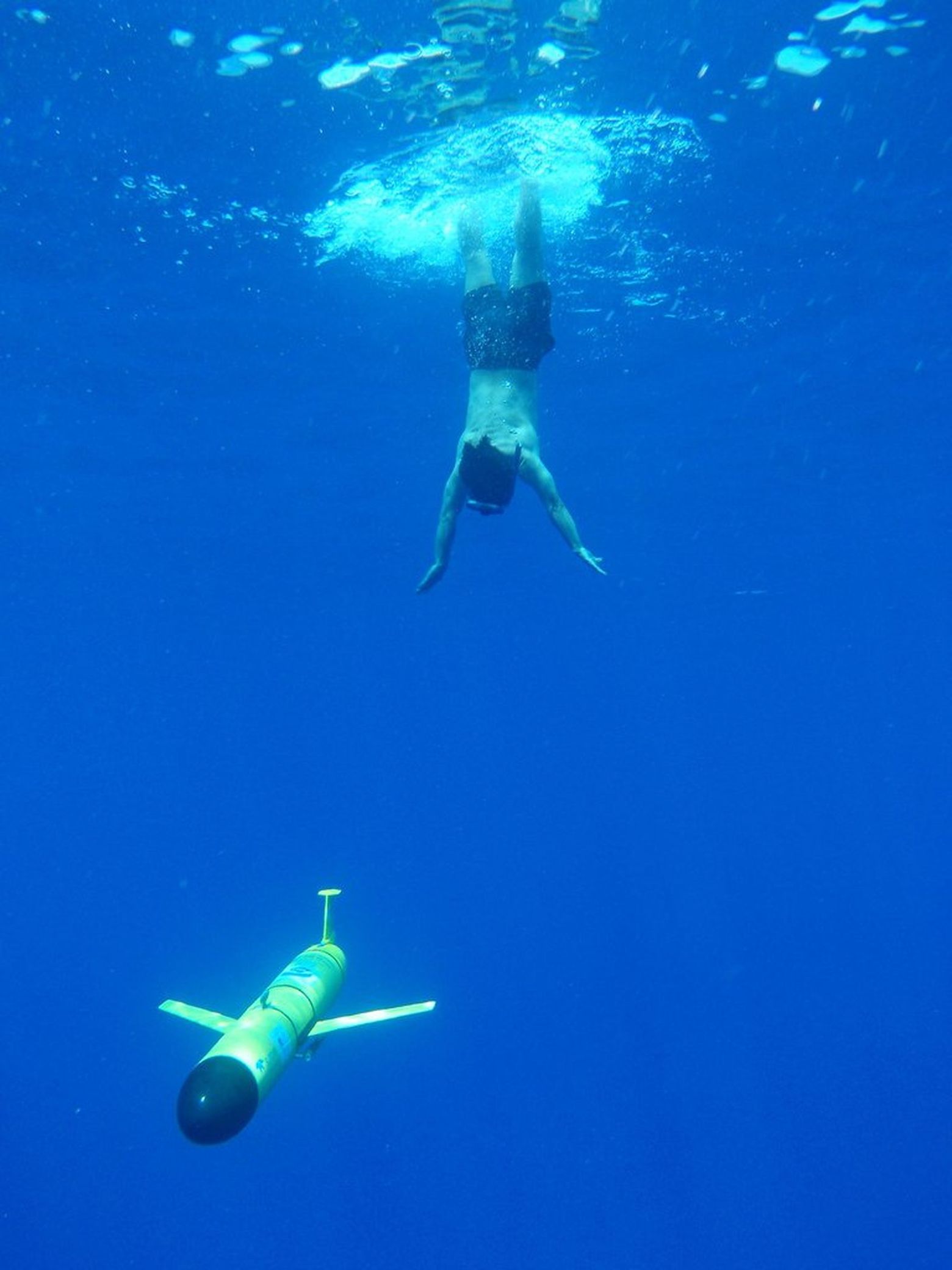 Underwater Photographer Free Diving Deep To Ocean Floor In Hawaii
