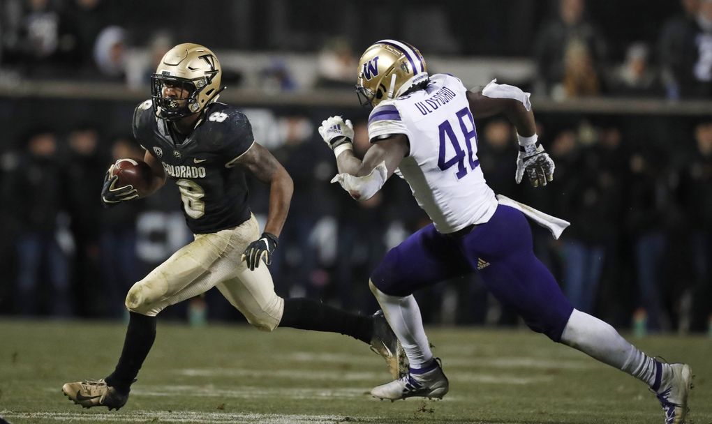 Colorado running back Alex Fontenot, left, runs for a short gain as Washington linebacker Edefuan Ulofoshio pursues during the second half of an NCAA college football game Saturday, Nov. 23, 2019, in Boulder, Colo. Colorado won 20-14. (David Zalubowski / The Associated Press)