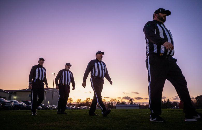 Football officials, from left, Eric Cheatley, Mike Kelley, Bryan Keatley and Jason Kelley take to the field before Friday night’s football game between Adna High School and Onalaska High School in Adna on Oct. 25, 2019. 211906