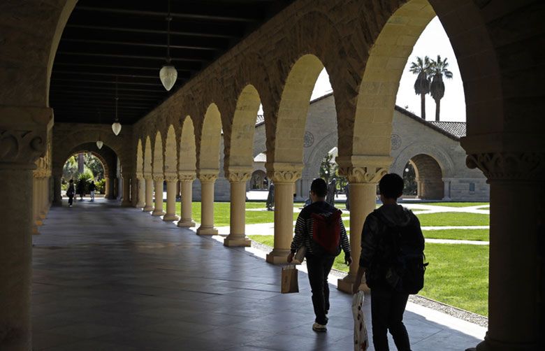 People walk on the Stanford University campus in Santa Clara, California. Seven percent of employers offer student loan repayment assistance as a benefit. For most companies, this benefit means making a direct payment to eligible employees’ loan. (AP file photo by Ben Margot)
