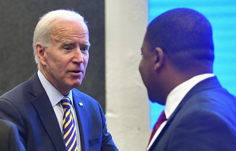 FILE – In this Nov. 21, 2019, file photo,  Democratice presidential candidate former Vice President Joe Biden is greeted by Fayetteville (N.C.) Mayor Mitch Colvin, right, after talking to Talladega (Ala.) Nayor Timothy Ragland, left, as he visits with an assembly of Southern black mayors in Atlanta. Biden is leading the most diverse presidential field in history among black voters. (AP Photo/John Amis, File) WX103 WX103