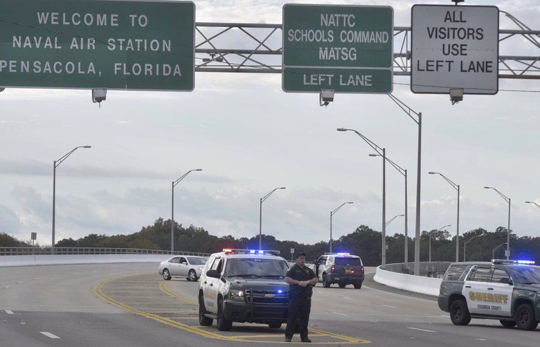 Police vehicles block the entrance to the Pensacola Air Base, Friday, Dec. 6, 2019 in Pensacola, Fla. The US Navy is confirming that a shooter is dead and several injured after gunfire at the Naval Air Station in Pensacola. (Tony Giberson/ Pensacola News Journal via AP) FLPEJ103 FLPEJ103