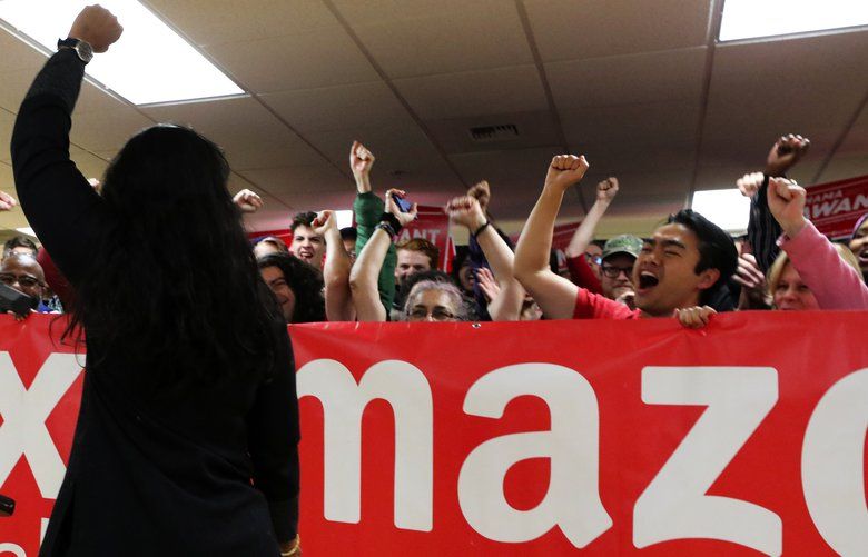 Fist raised in victory, council member Kshama Sawant is received with cheers by her supporters behind a “Tax Amazon” banner Saturday morning.

OUTS: SEATTLE OUT, USA TODAY OUT, CROSSCUT OUT, MAGAZINES OUT, TELEVISION OUT, SALES OUT. MANDATORY CREDIT TO: ALAN BERNER / THE SEATTLE TIMES.