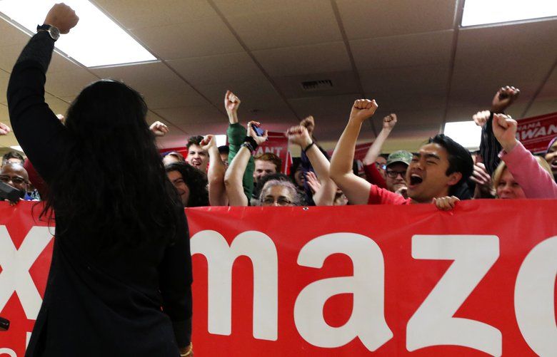 Fist raised in victory, council member Kshama Sawant is received with cheers by her supporters behind a “Tax Amazon” banner Saturday morning.
OUTS: SEATTLE OUT, USA TODAY OUT, CROSSCUT OUT, MAGAZINES OUT, TELEVISION OUT, SALES OUT. MANDATORY CREDIT TO: ALAN BERNER / THE SEATTLE TIMES.