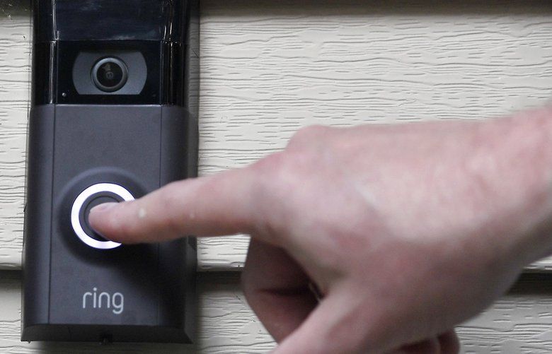 FILE – In this Tuesday, July 16, 2019, file photo,  pushes the doorbell on his Ring doorbell camera. Amazon-owned doorbell camera company Ring is neighborhoods.(AP Photo/Jessica Hill, File) NY112