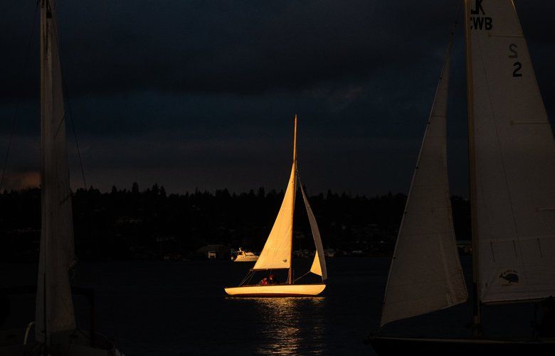 Boats sail around Lake Union as the sun sets on Dec. 15, 2019. 212411  LO