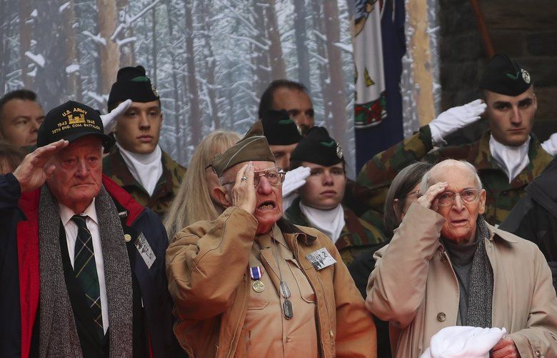 U.S. Battle of the Bulge veterans, front row, listen to the U.S. national anthem during a ceremony to commemorate the 75th anniversary of the Battle of the Bulge at the Mardasson Memorial in Bastogne, Belgium on Monday, Dec. 16, 2019. The Battle of the Bulge, also called Battle of the Ardennes, took place between Dec. 1944 and Jan. 1945 and was the last major German offensive on the Western Front during World War II. (AP Photo/Francisco Seco) FS101 FS101