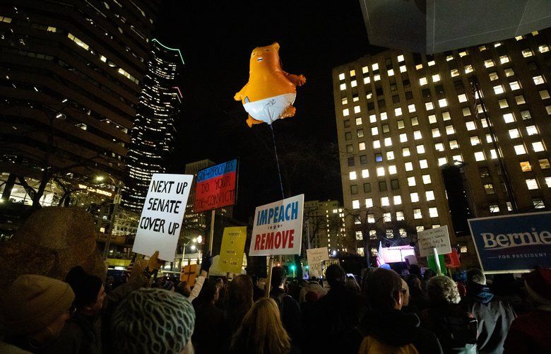 A Donald Trump balloon floats above the crowd during the Seattle Indivisible protest at Henry M. Jackson Federal Building on Dec. 17, 2019. 212439