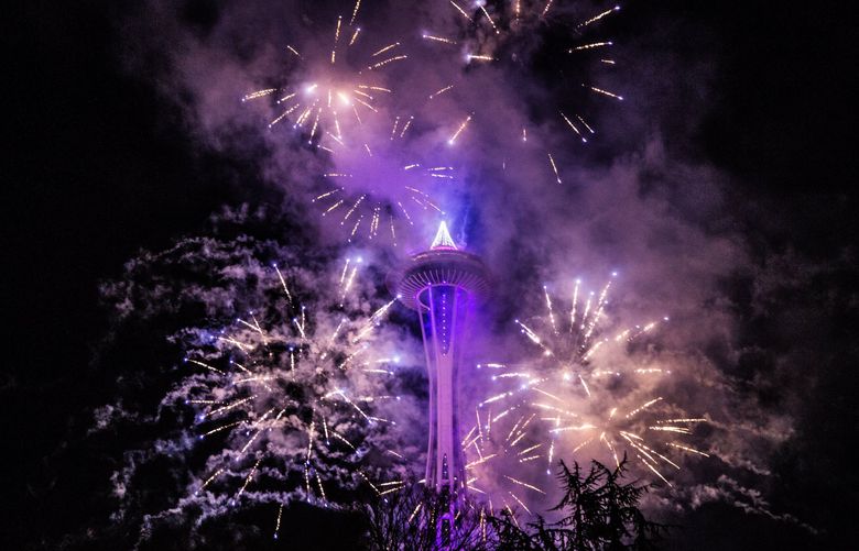 Fireworks shoot off from the Space Needle on Monday, December 31, as a part of the New Years Eve at the Needle celebration before the fireworks.  (Rebekah Welch / The Seattle Times)