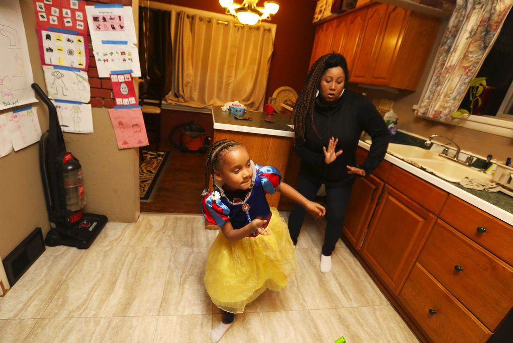 With music playing, Shauna Robinson dances with Terricca, who’s come a long way from the girl who a couple years ago barely talked. (Ken Lambert / The Seattle Times)