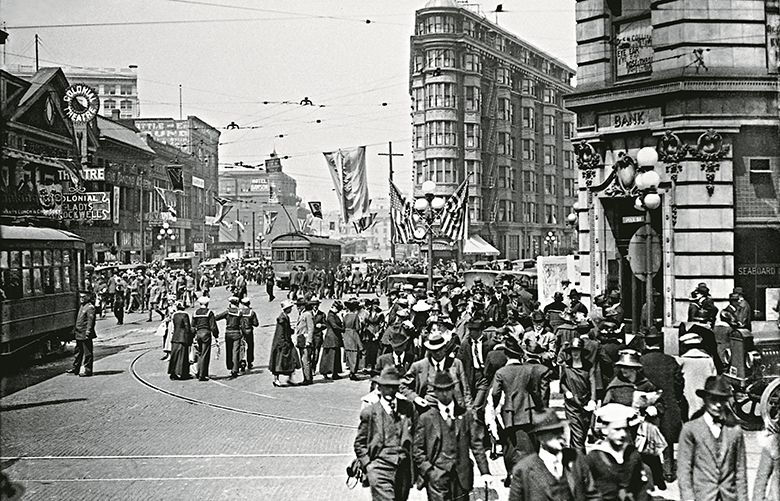 Then: Dorpat’s first look back, at March 12, 1919. Uniformed soldiers and sailors and Seattle citizens mingle as the city celebrates the homecoming of”Seattle’s Own Regiment, the 63rd Coast Artillery.”