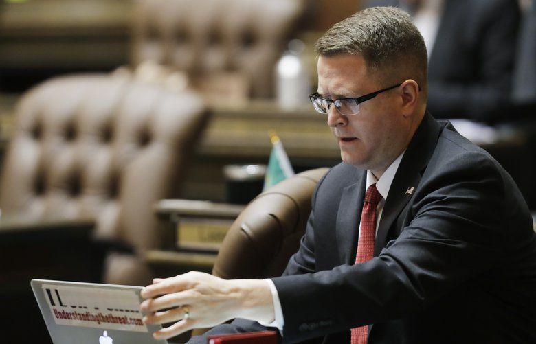 FILE – In this April 22, 2019 file photo, Washington State Rep. Matt Shea, R-Spokane Valley, adjusts his laptop computer on the floor of the House, at the Capitol in Olympia, Wash. An investigative report prepared for the state Legislature and released Thursday, Dec. 19, 2019 said that Shea took part in “domestic terrorism” against the United States during a 2016 standoff at a wildlife refuge in Oregon and traveled throughout the West meeting with far-right extremist groups. (AP Photo/Ted S. Warren, File) WATW204 WATW204