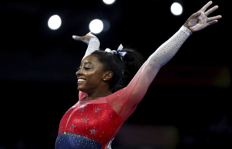 File-This Oct. 8, 2019, file photo shows Simone Biles of the U.S. performs on the vault during the women’s team final at the Gymnastics World Championships in Stuttgart, Germany. Biles is the 2019 AP Female Athlete of the Year. She is the first gymnast to win the award twice and the first to win it in a non-Olympic year. (AP Photo/Matthias Schrader, File) NYSH206 NYSH206