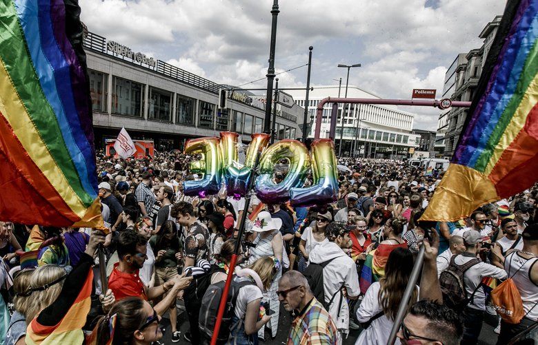 In this file photo, revelers take part in the annual Christopher Street Day parade on July 27, 2019 in Berlin, Germany. Some transgender people in Germany are pushing for the government to apologize for forcing them to undergo sterilization to have their change of gender legally recognized. (Carsten Koall/Getty Images/TNS) 1530837 1530837
