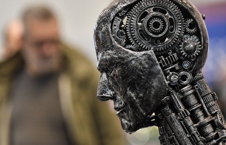 FILE – In this Nov. 29, 2019, file photo, a metal head made of motor parts symbolizes artificial intelligence, or AI, at the Essen Motor Show for tuning and motorsports in Essen, Germany.  (AP Photo/Martin Meissner, File) 