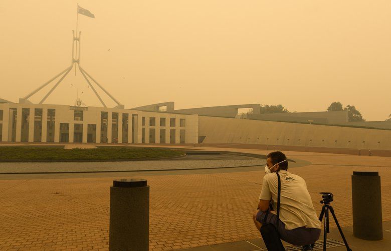 A photographer captures smoke at Parliament House on January 05, 2020 in Canberra, Australia. Smoke haze across Eastern Australian cities has become common in recent months as bushfires continue to burn. Hundreds of fires continue to burn in NSW, Victoria and South Australia, with the Australian Defence Force now called in to help with firefighting and rescue efforts. 14 people have died in the fires in NSW, Victoria and SA since New Year’s Eve. (Rohan Thomson/Getty Images/TNS) 1532817 1532817