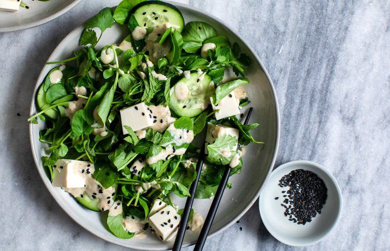 Tarragon, dill, shiso, mint, basil, cilantro, parsley and watercress are paired with cool, custardy silken tofu in a salad, in New York, Dec. 15, 2019. For exquisitely simple dishes that don’t skimp on flavor, David Tanis looks to Japan. (Andrew Scrivani/The New York Times) XNYT45
