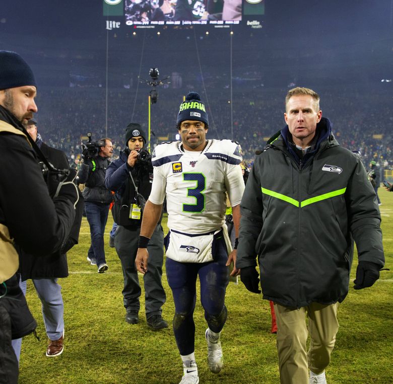 Packers quarterback Aaron Rodgers alerts the ref to a face mask call after  getting sacked during the 1st half of Green Bay's NFL game against the  Seattle Seahawks in Seattle, Washington, Monday