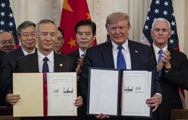 Chinese Vice Premier Liu He and President Donald Trump display their signed limited trade agreements at the White House in Washington on Wednesday, Jan. 15, 2020. The agreement includes some wins for President Trump but implementing and enforcing the deal could be difficult. (Pete Marovich/The New York Times) XNYT132 XNYT132