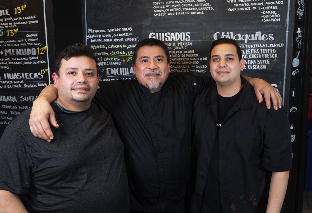 Brothers Jared, left, and Noe Velazquez Ayala, center, with Jared’s son, Abinadi Velazquez, run the daily operations at El Catrin, which serves some of the best Mexican food in the Seattle area. (Ellen M. Banner / The Seattle Times)