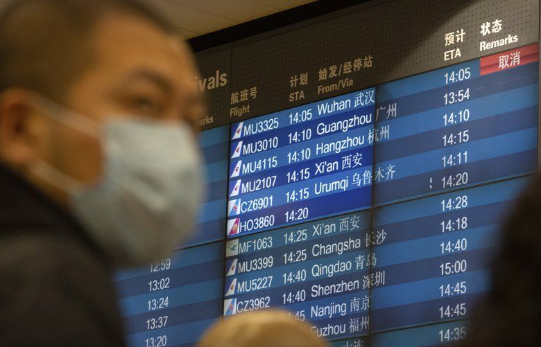 A display board shows a canceled flight arrival from Wuhan at Beijing Capital International Airport in Beijing, Thursday, Jan. 23, 2020. China closed off a city of more than 11 million people Thursday, halting transportation and warning against public gatherings, to try to stop the spread of a deadly new virus that has sickened hundreds and spread to other cities and countries in the Lunar New Year travel rush. (AP Photo/Mark Schiefelbein) XMAS106 XMAS106