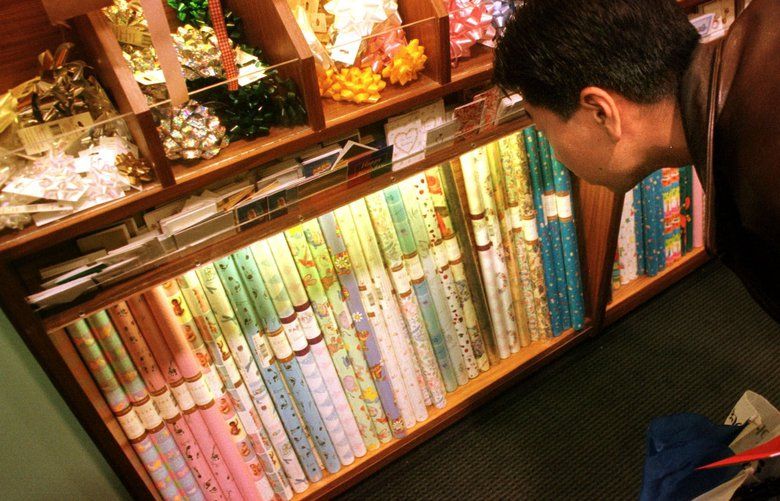 Retsu Ikeda examines the selection of wrapping paper at Papyrus, a specialty store in downtown San Francisco, California on Thursday, December 21, 2000.  Peter Appert, an analyst for Deutsche Banc Alex Brown in San Francisco has been forecasting holiday sales by analyzing the sales of wrapping paper.  Appert says that this year gift-wrap sales are the weakest they’ve been in five years, and that would imply, not surprisingly that retail sales would be down as well.  Photographer:  Noah Berger.  Bloomberg News. 12/21/00